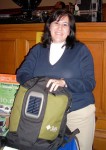 woman holding a backpack with a solar panel